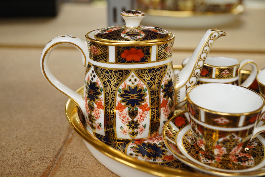 A small collection of Royal Crown Derby miniature tea for two and a pill box, tray 19cm wide. Saucer missing on tea for two.